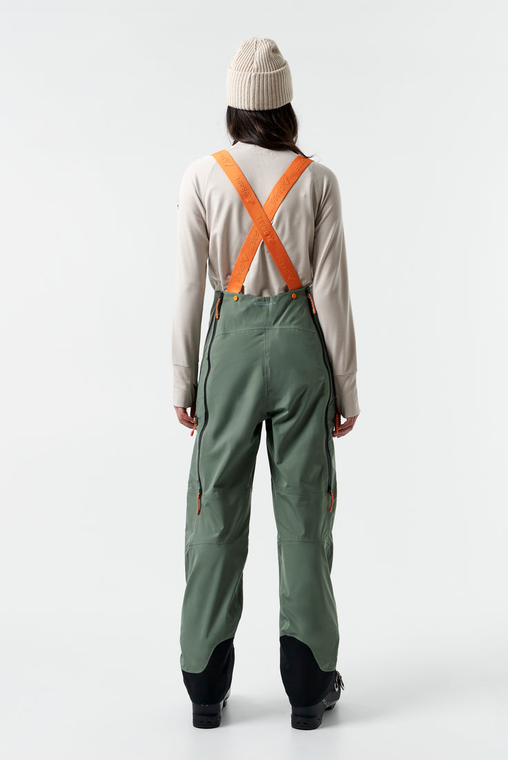baksiden av en grønn ski bukse med oransje stropper